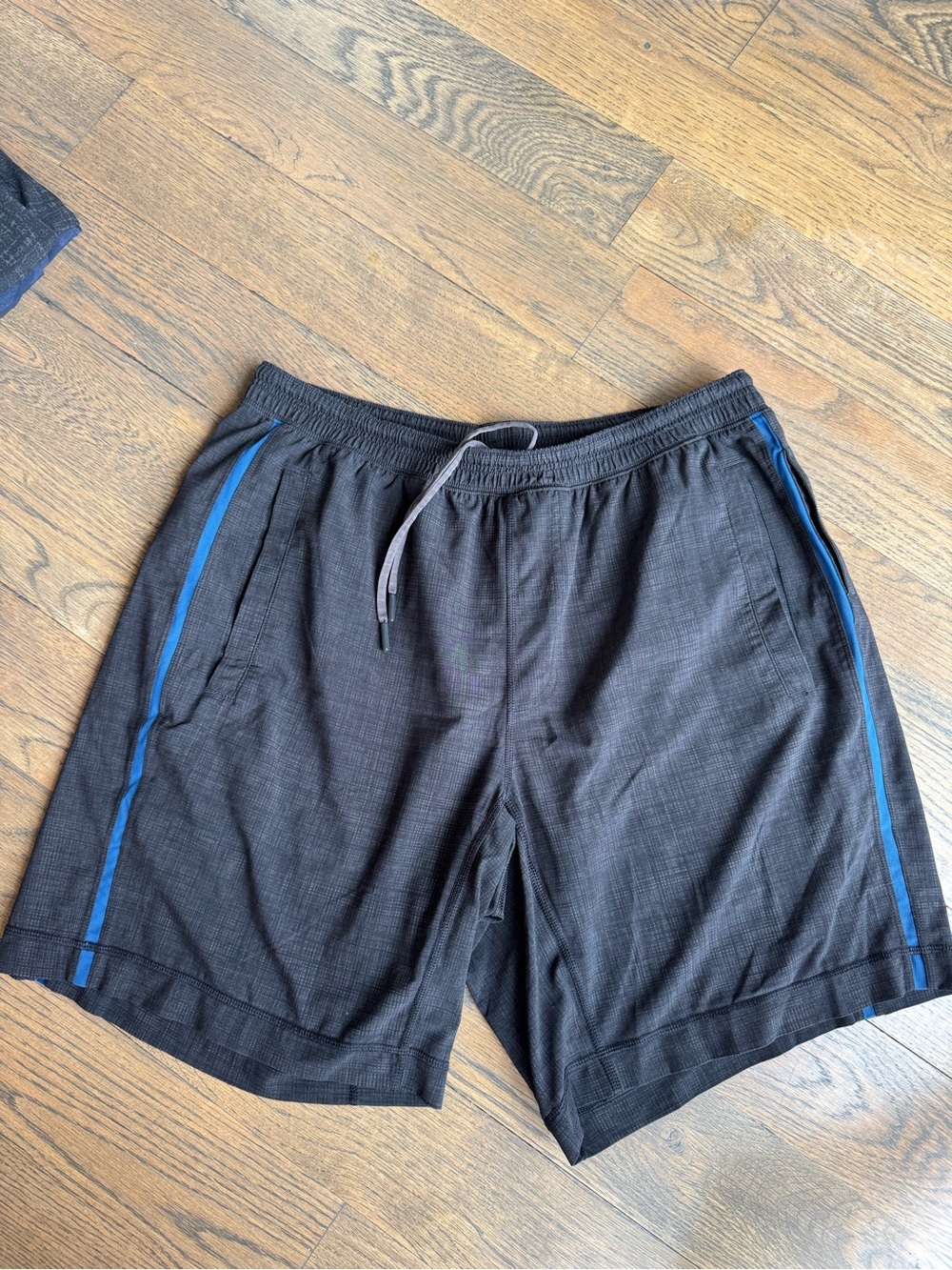 Lululemon Men's Black Athletic Shorts with Blue Stripe